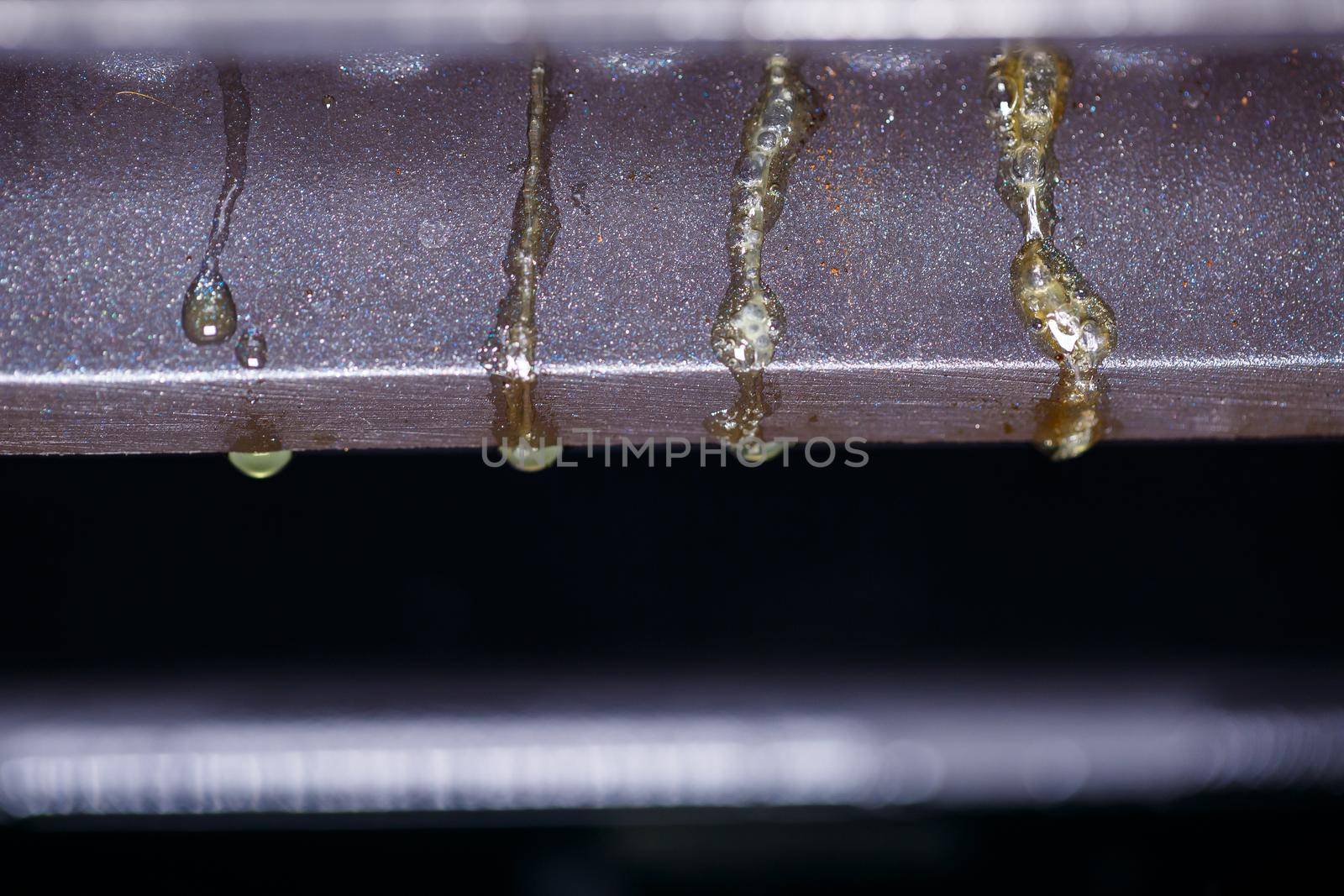 drops of fat flowing from the electric grill during meat cooking