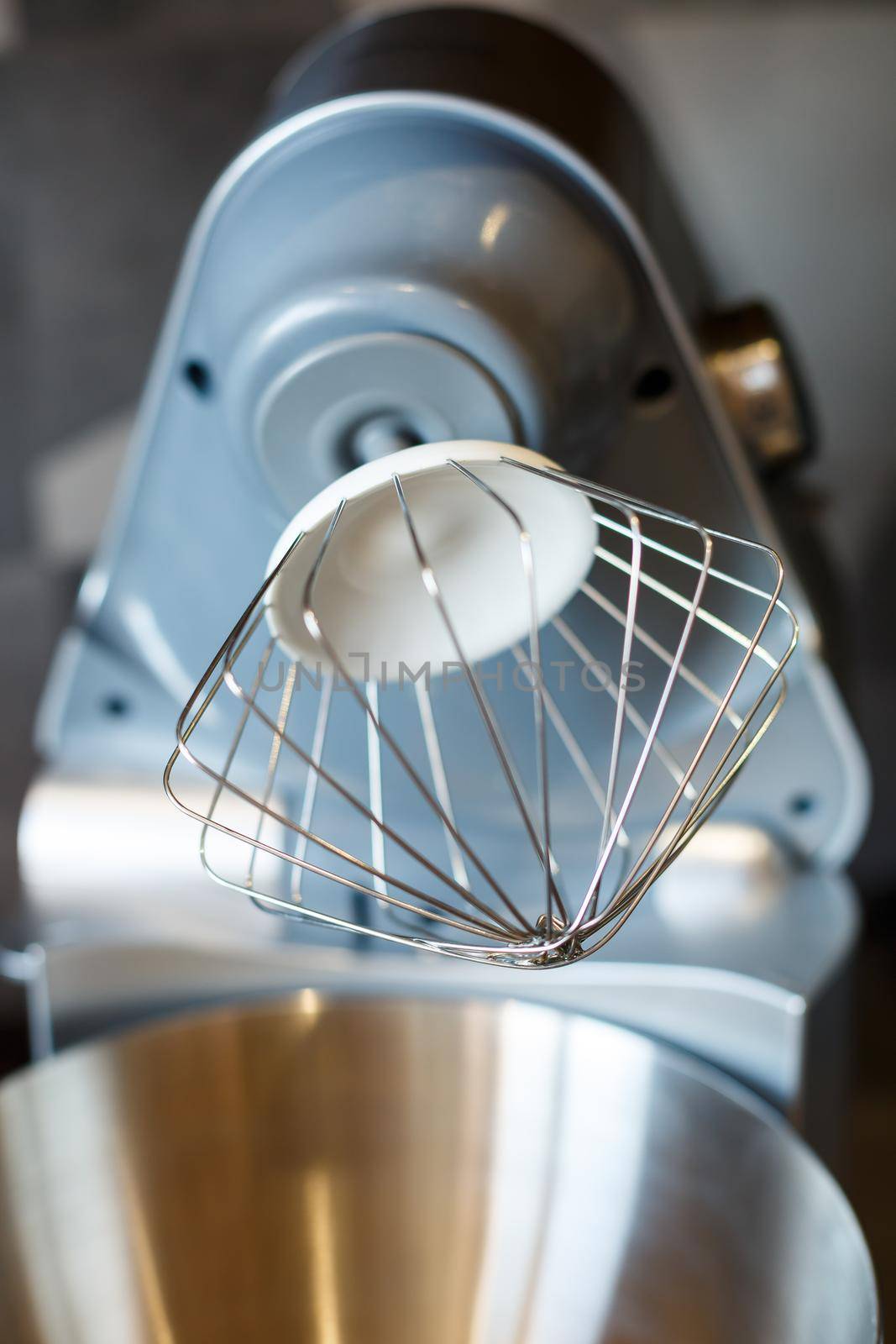 Beating eggs with sugar in a kitchen machine. Cream nozzle