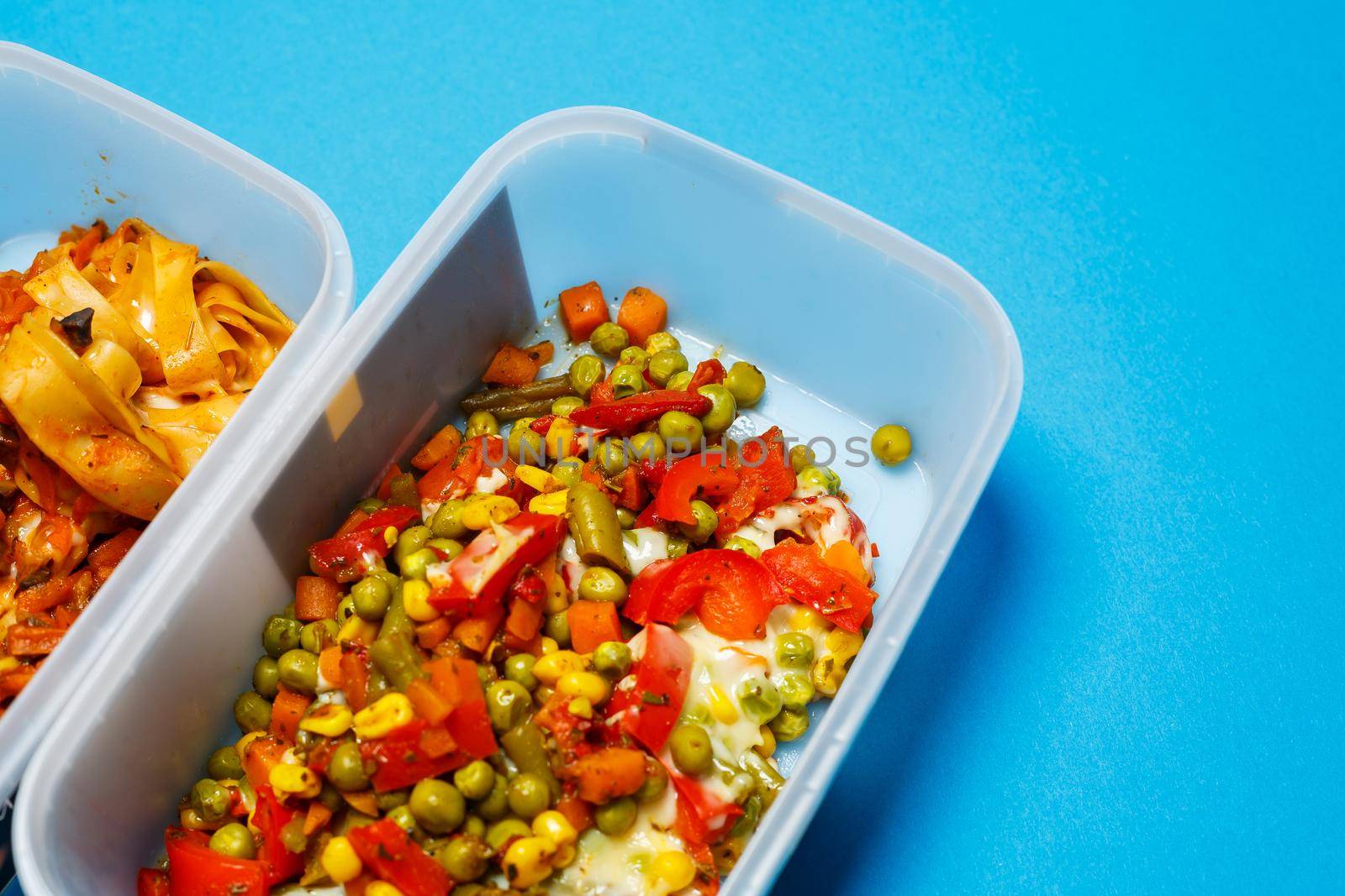 Braised pasta with vegetables in a plastic tray. Lunch for the office worker