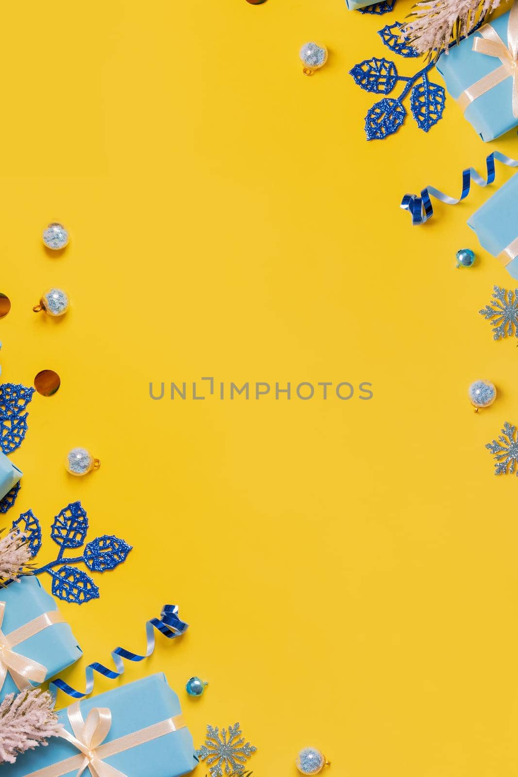 Vertical mock up Christmas greeting card with flat lay gift boxes and bows with copy space top view on colored background. Ukrainian trendy colors