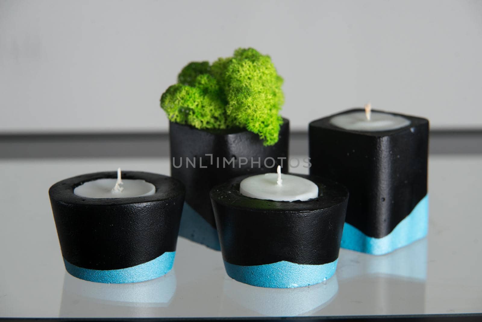 Candles and moss in black and blue concrete candle holders by Ashtray25