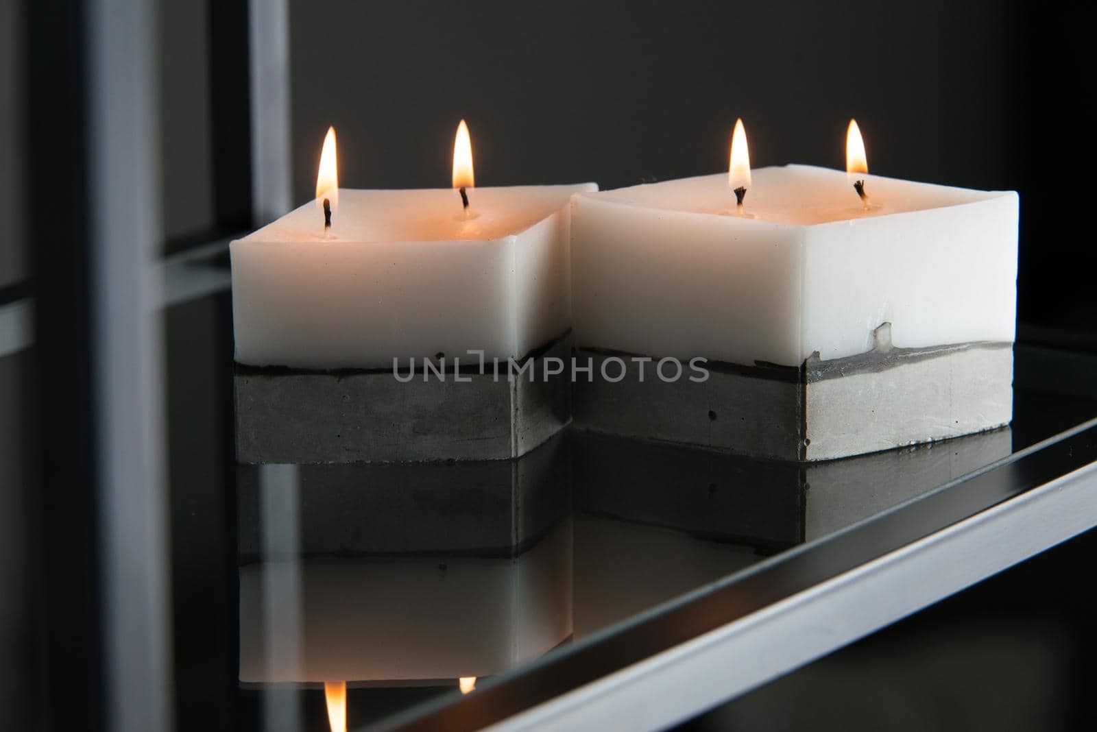 white candle on a concrete base by Ashtray25