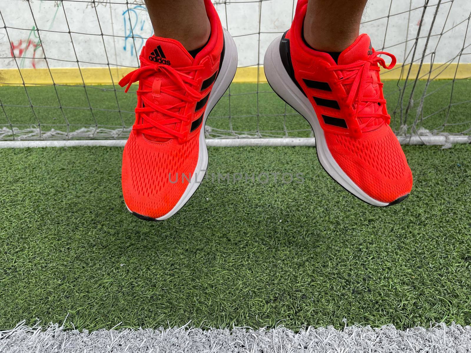 Tyumen, Russia-August 13, 2022: New Adidas Running Shoes, orange coral color, eq21 run.