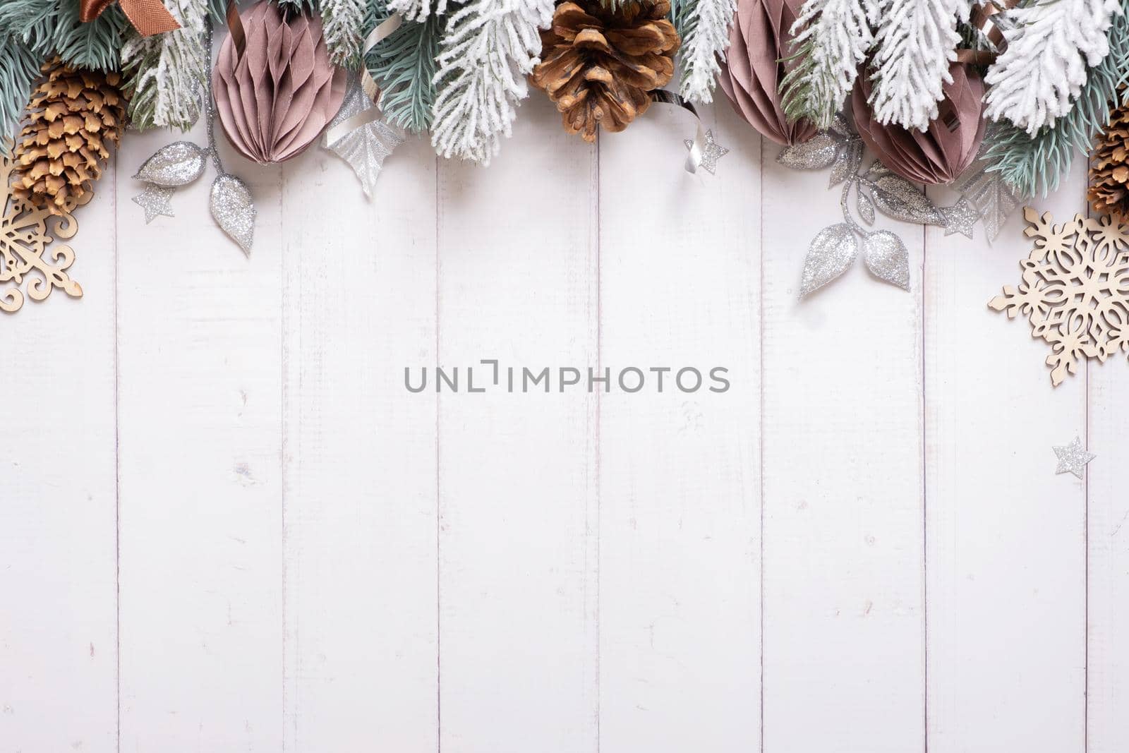 Christmas flat lay composition from pine, cones, balls on wooden background top view. Copy space.