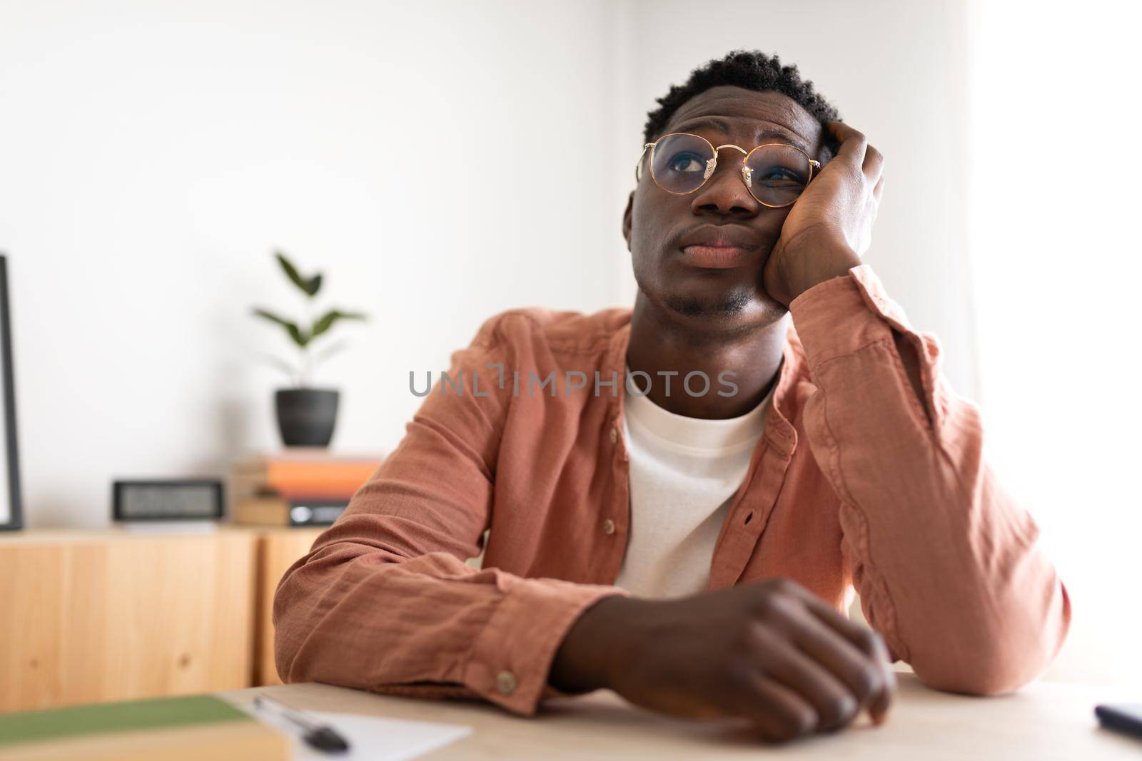 Bored and tired African American teen college student during boring lesson video call. Technology concept. E-learning and Education concepts.