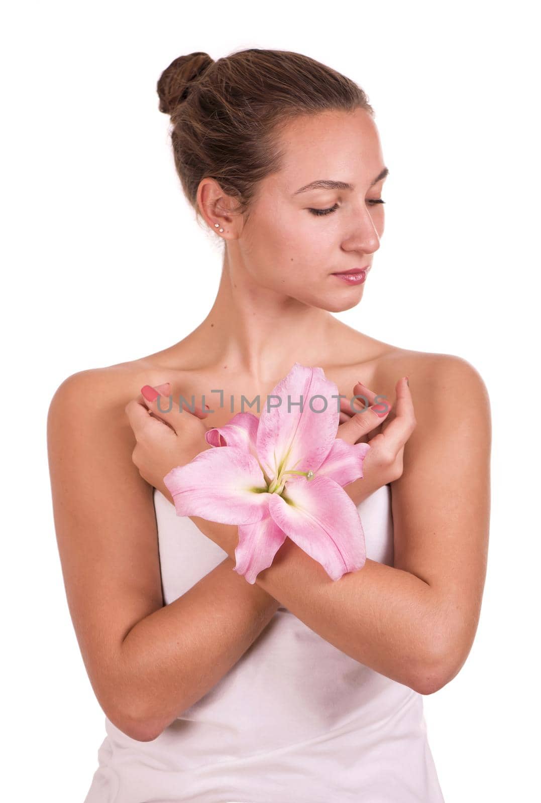 Beauty face of the young beautiful woman with flower. Female touching skin. by aprilphoto