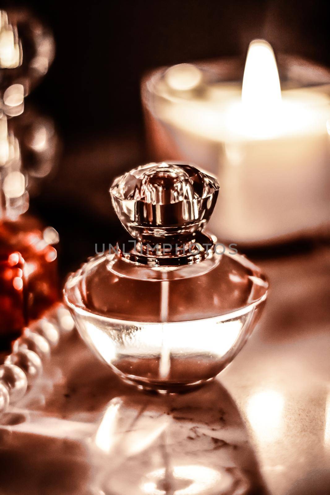 Perfumery, cosmetics branding and luxe concept - Perfume bottle and vintage fragrance on glamour vanity table at night, pearls jewellery and eau de parfum as holiday gift, luxury beauty brand present