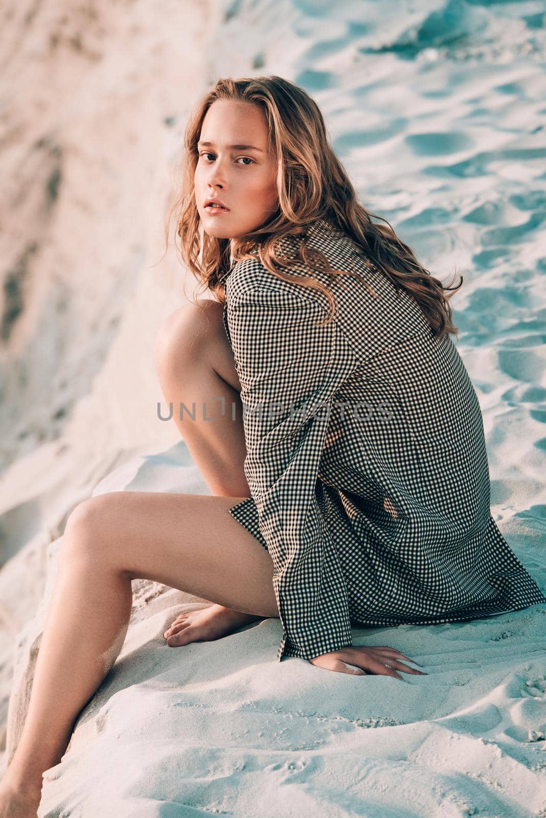 girl sitting at sandy beach. Outdoor portrait of pretty curly woman by Ashtray25