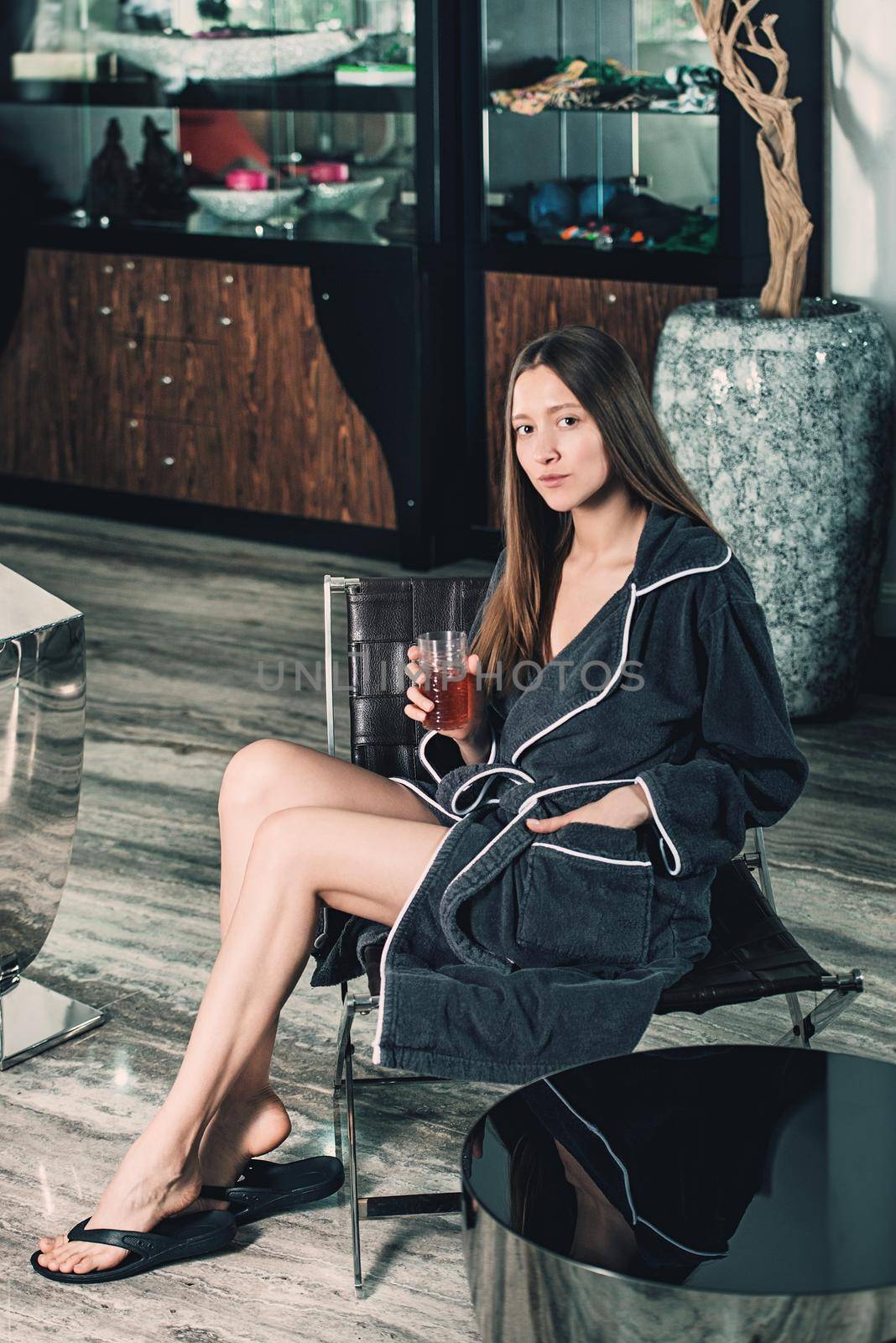 Beautiful woman relaxing in bathrobe in spa center by Ashtray25