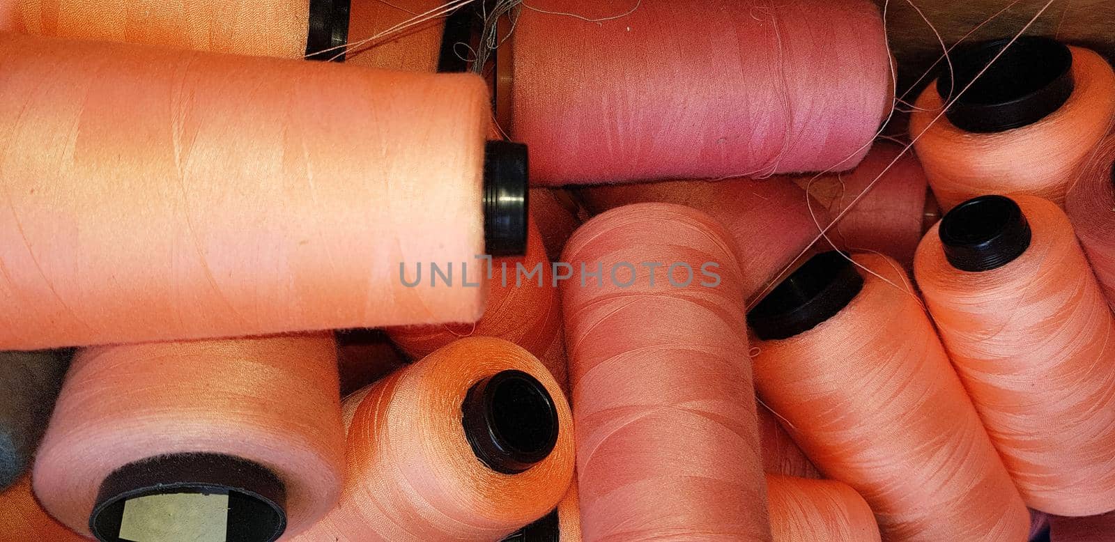 Colorful yarn on spool, yarn on tube, cotton, wool, linen thread orange by antoksena