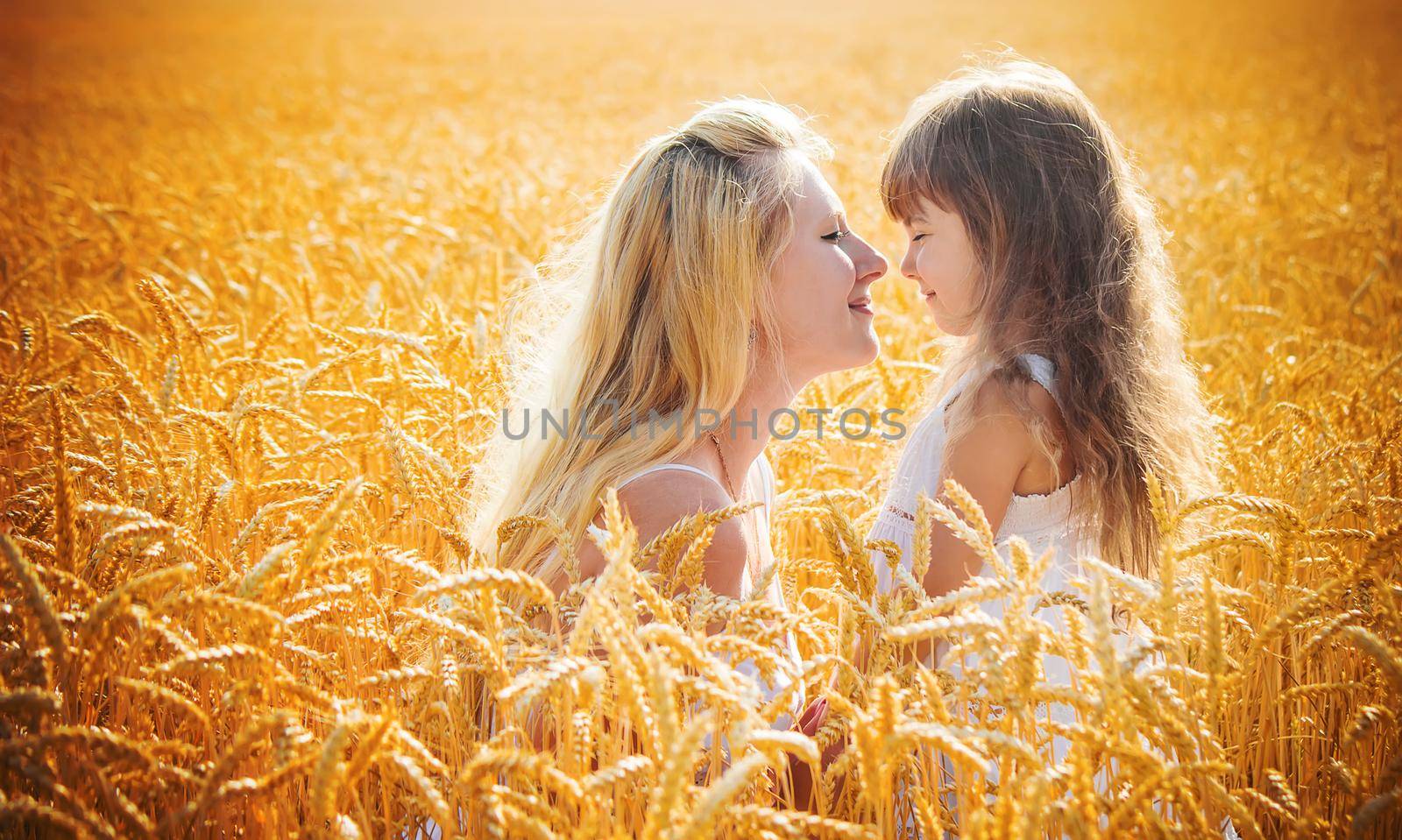 mother and daughter in a wheat field. selective focus. Nature.