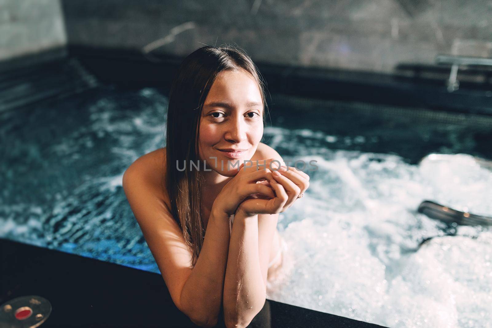 Sexy beautiful caucasian woman relaxing in a pool with jacuzzi. Dark room. Poor lighting by Ashtray25