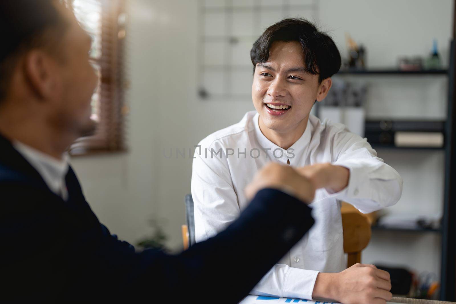 Business people showing Fist Bump after meeting partnership. Teamwork Concept