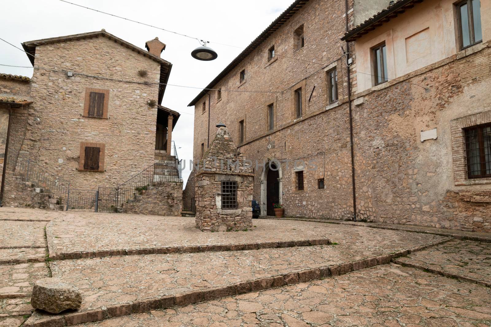 square with the well of Macerino, a historic town entirely made of stone, inhabited only in summer