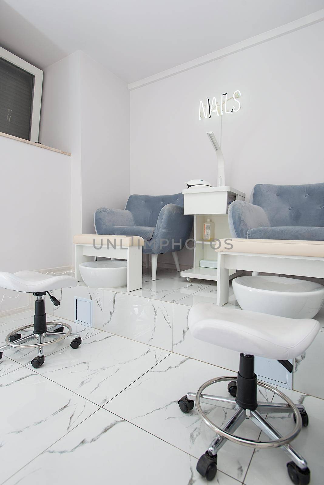 Interior of modern manicure salon without people. Luxury work places for masters of pedicure by Ashtray25