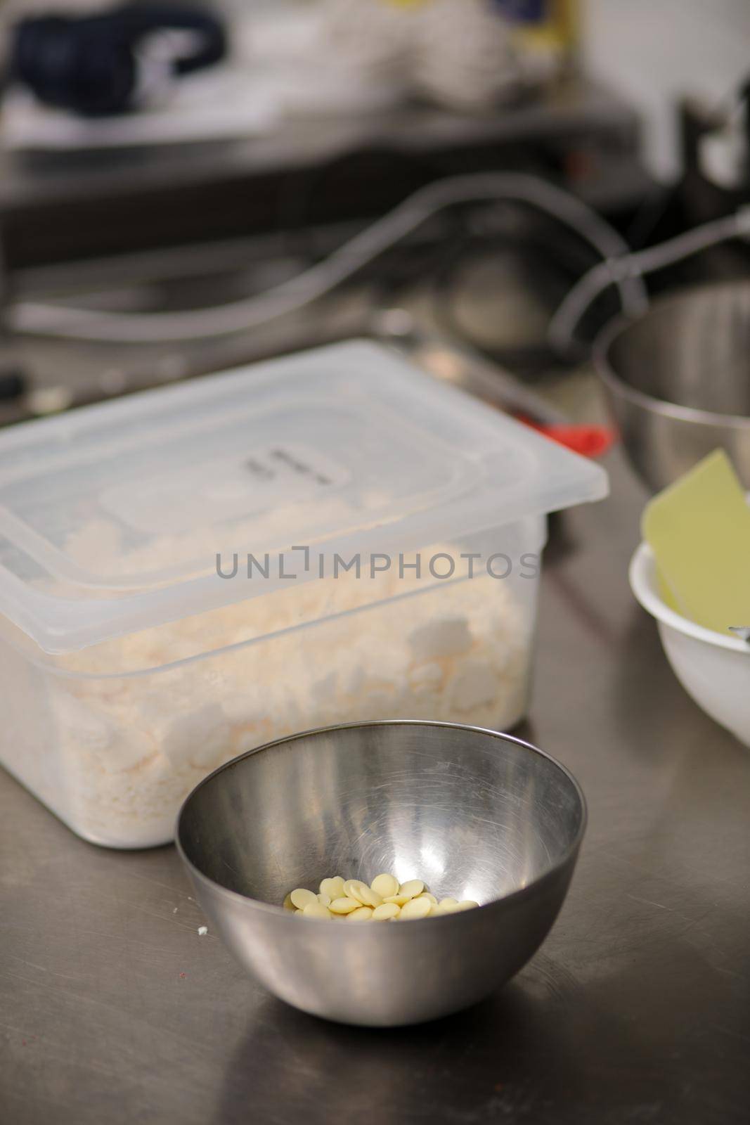 chef making for icing a lilac drip cake in the professional kitchen lab