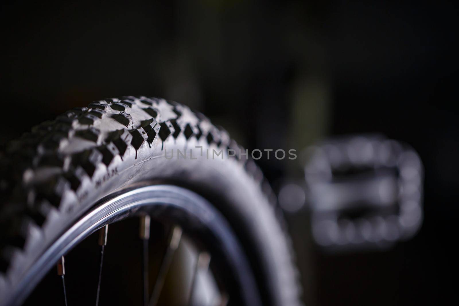 Black rubber tire with spikes for a bicycle wheel. Bike accessories