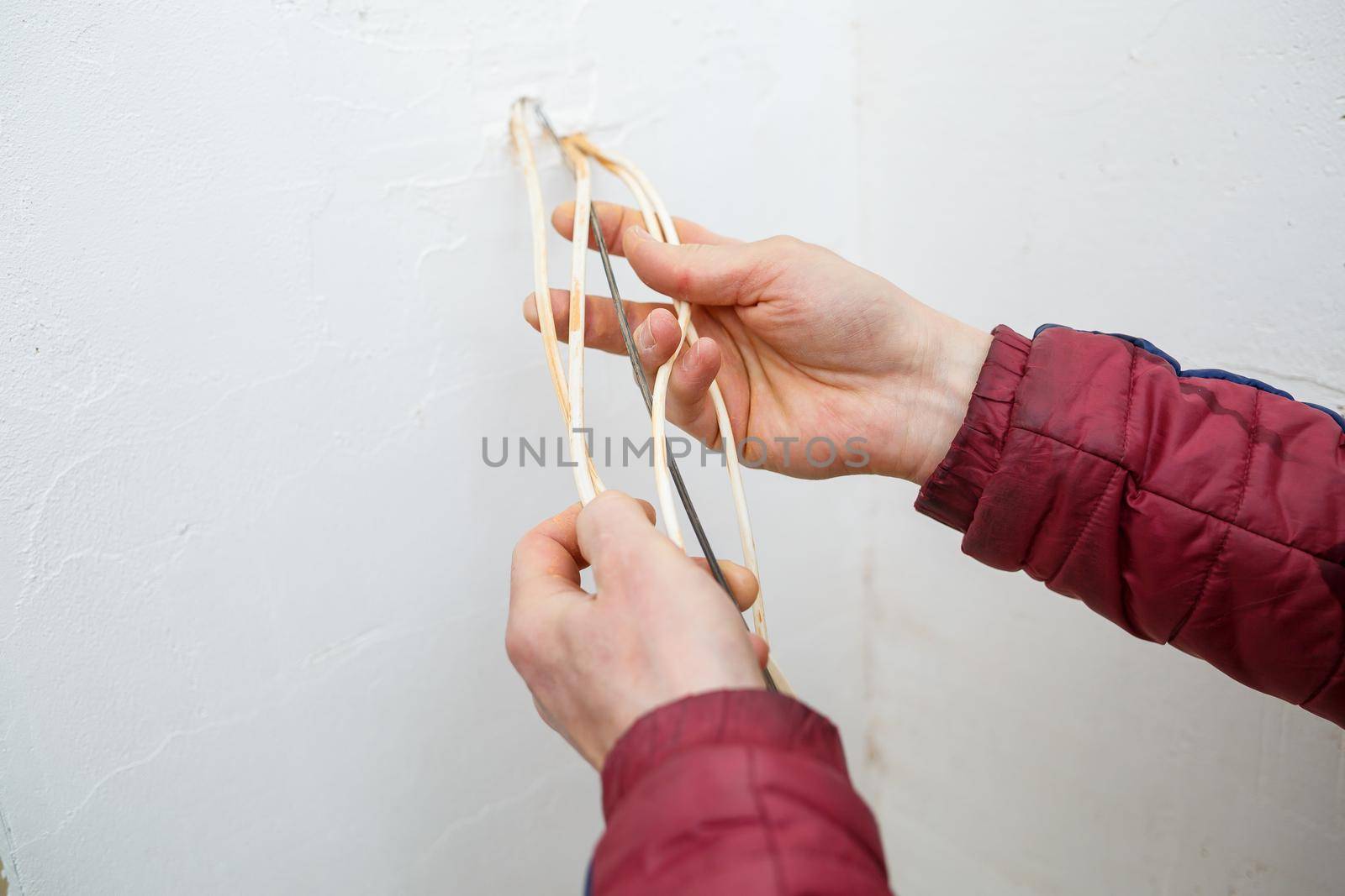 Electricity installation. During repair. open the wires. Sticking out isolated on a white wall. Professional installation electrically