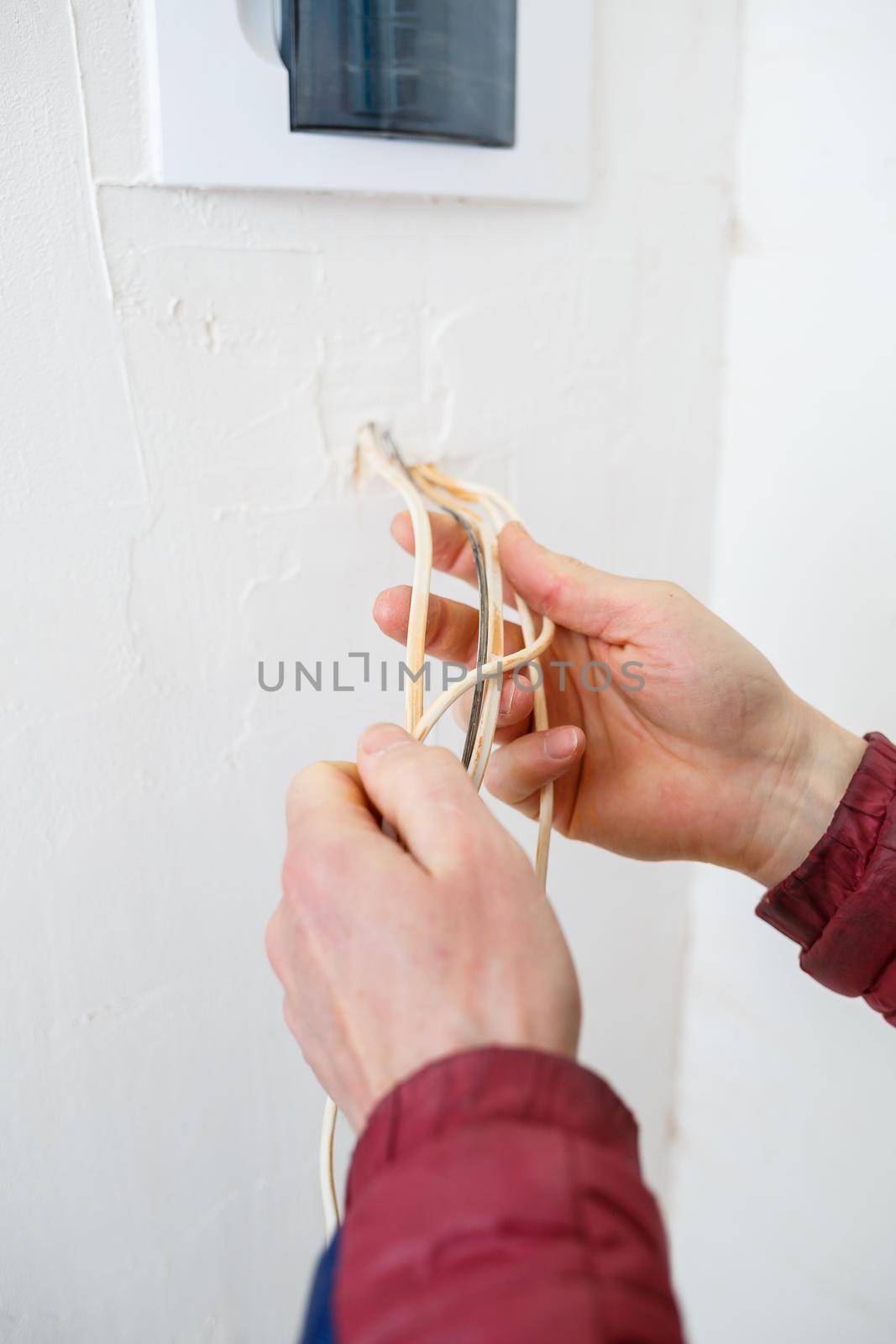 Electricity installation. During repair. open the wires. Sticking out isolated on a white wall. Professional installation electrically