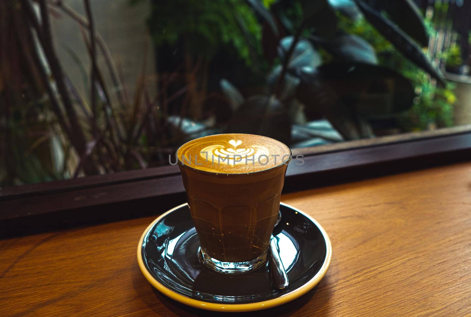A cup of coffee latte top view with Microfoam milk leaf shape foam. by Petrichor