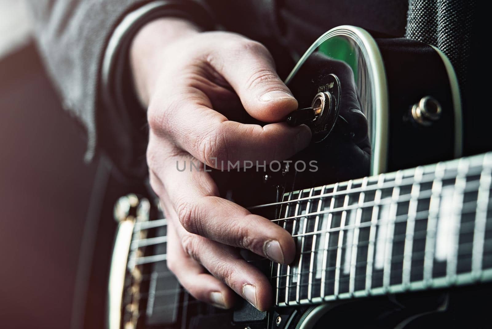 Close up shot of Hands of man playing electric guitar.