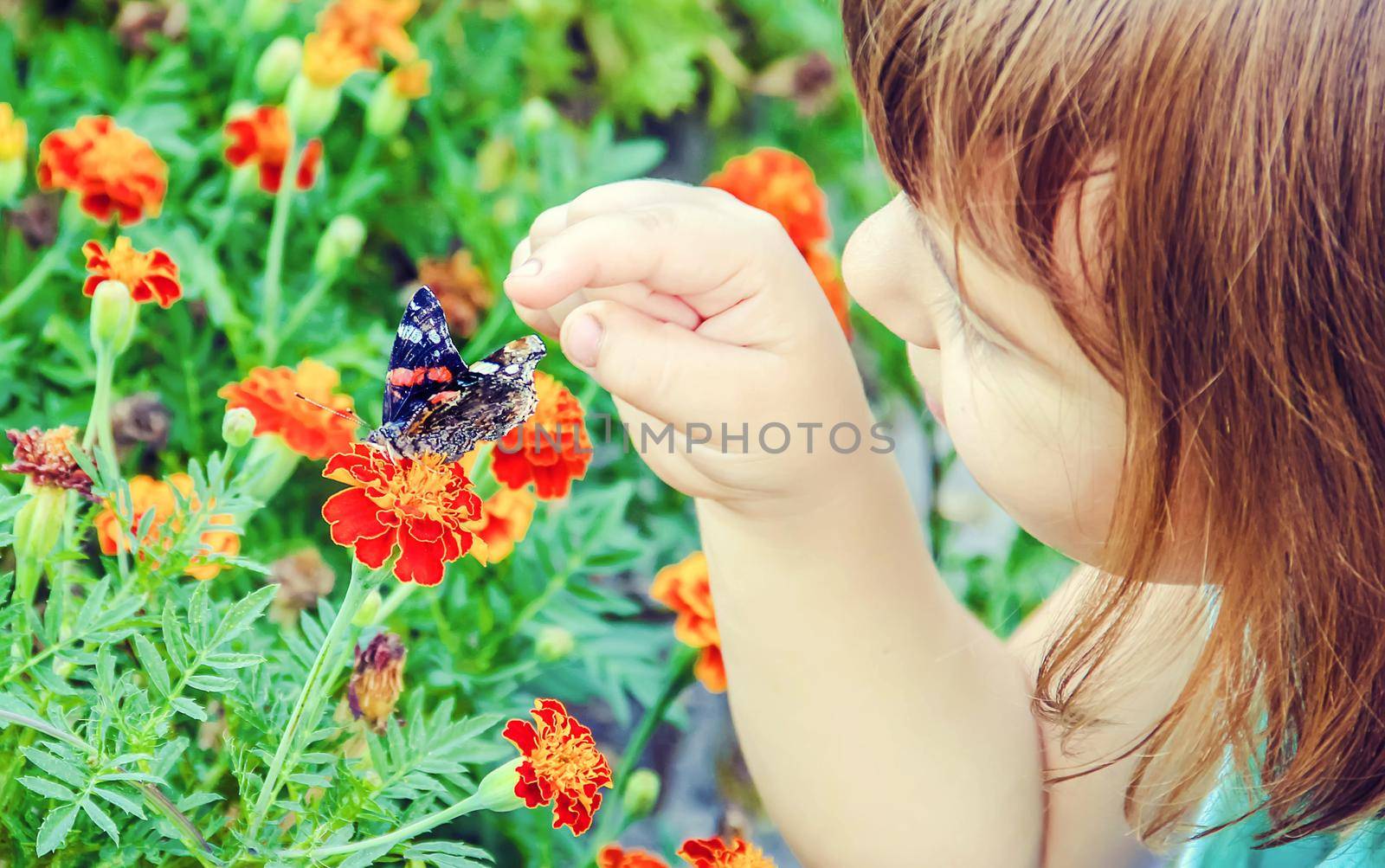 Child with a butterfly. Selective focus. nature and child.