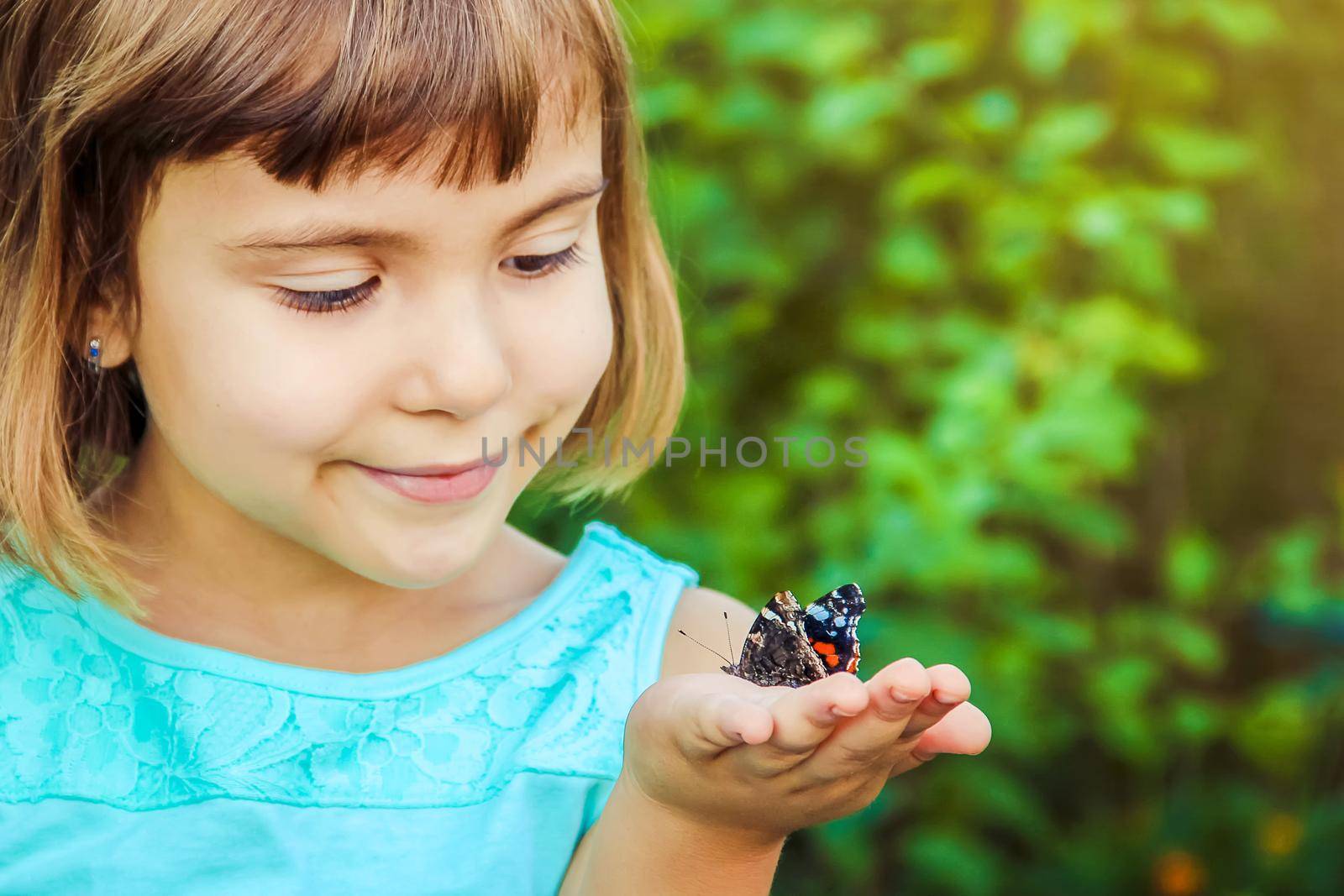 Child with a butterfly. Selective focus. nature and child.