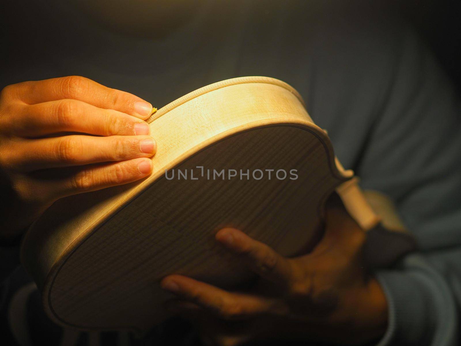 woman violinmaker at work with the fiddle