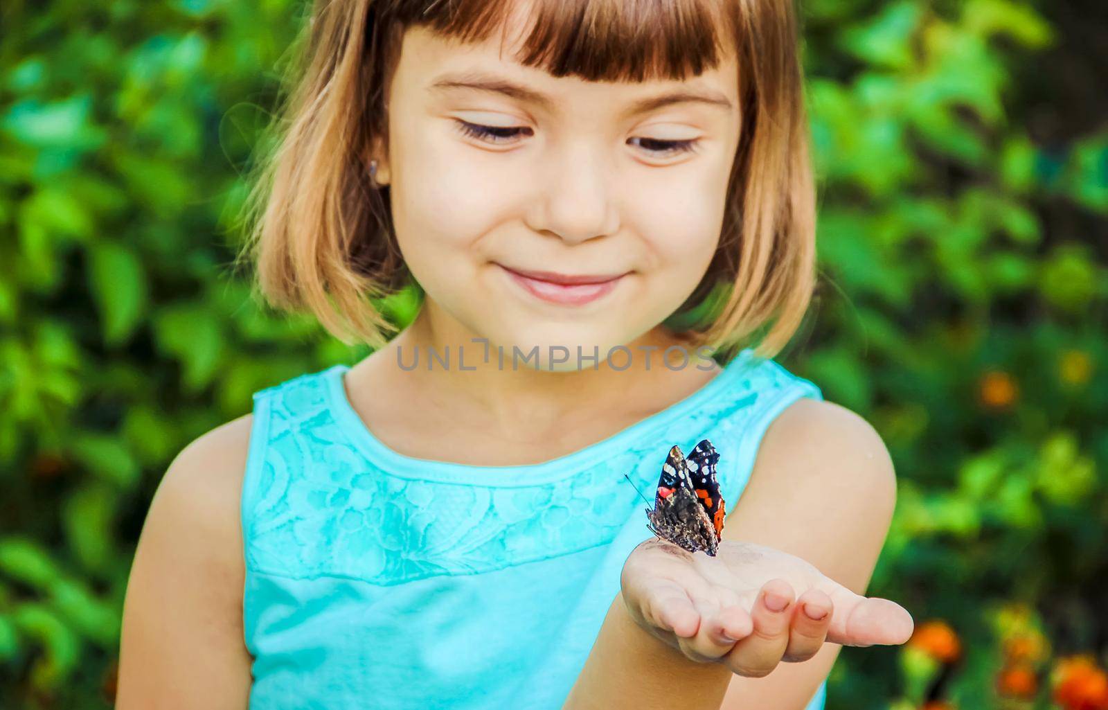 Child with a butterfly. Selective focus. nature and child.