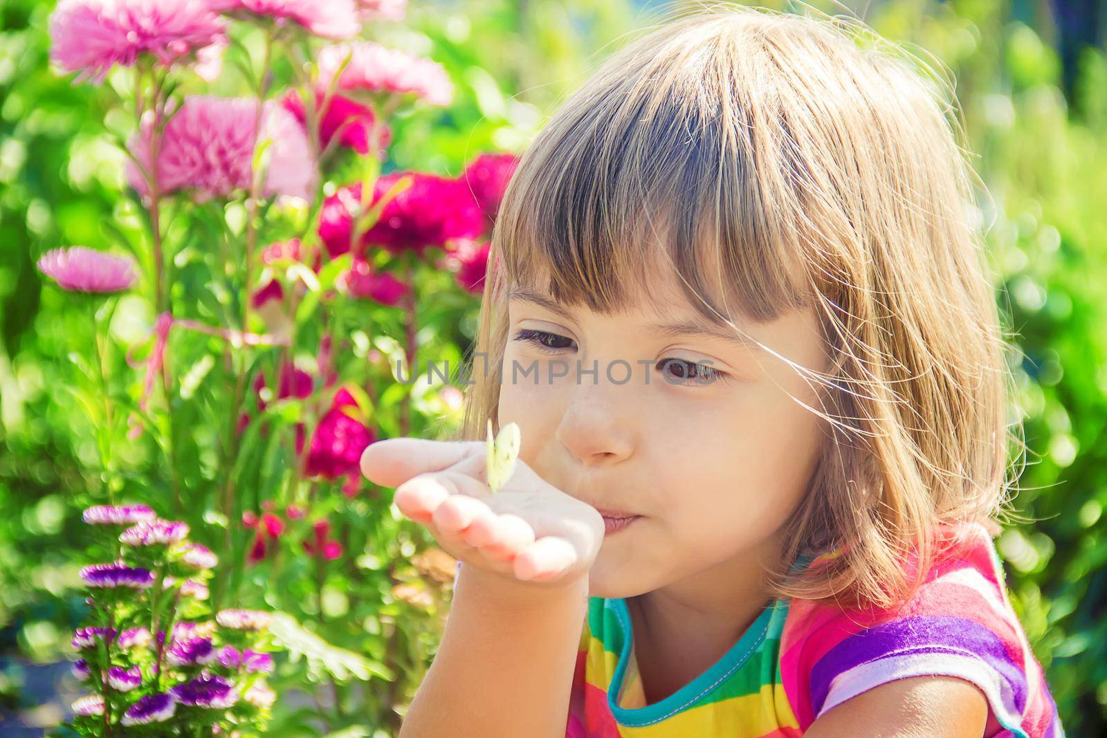 Child with a butterfly. Selective focus. nature and child.