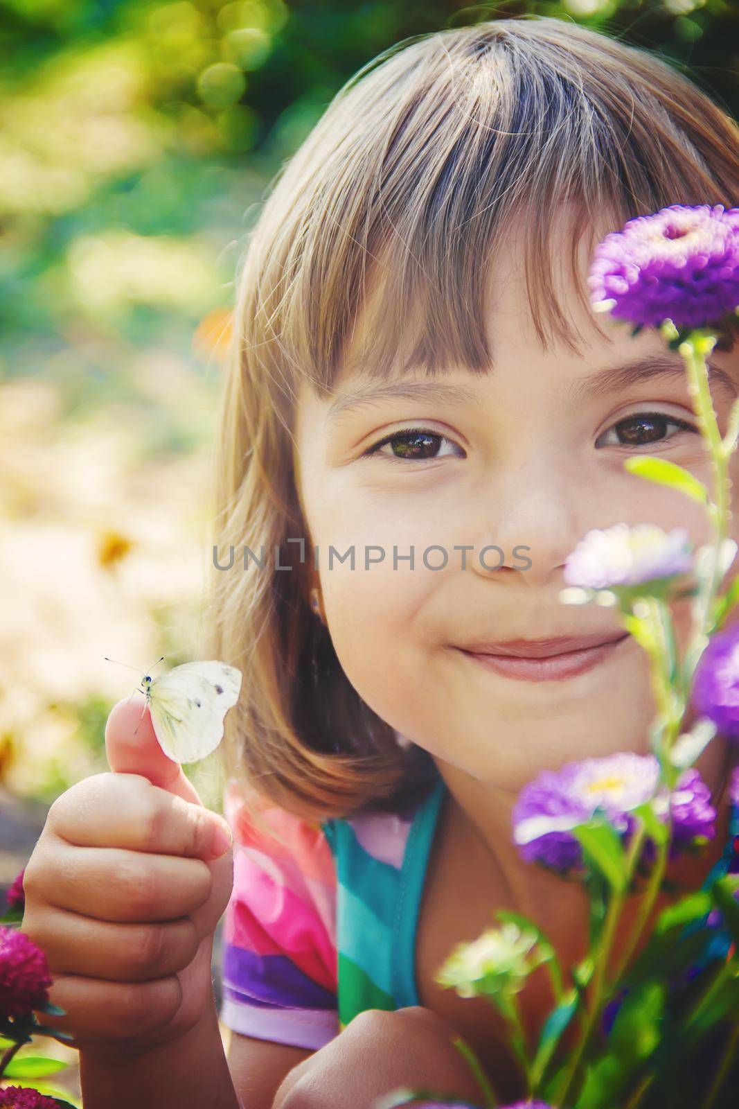 Child with a butterfly. Selective focus. nature and child.