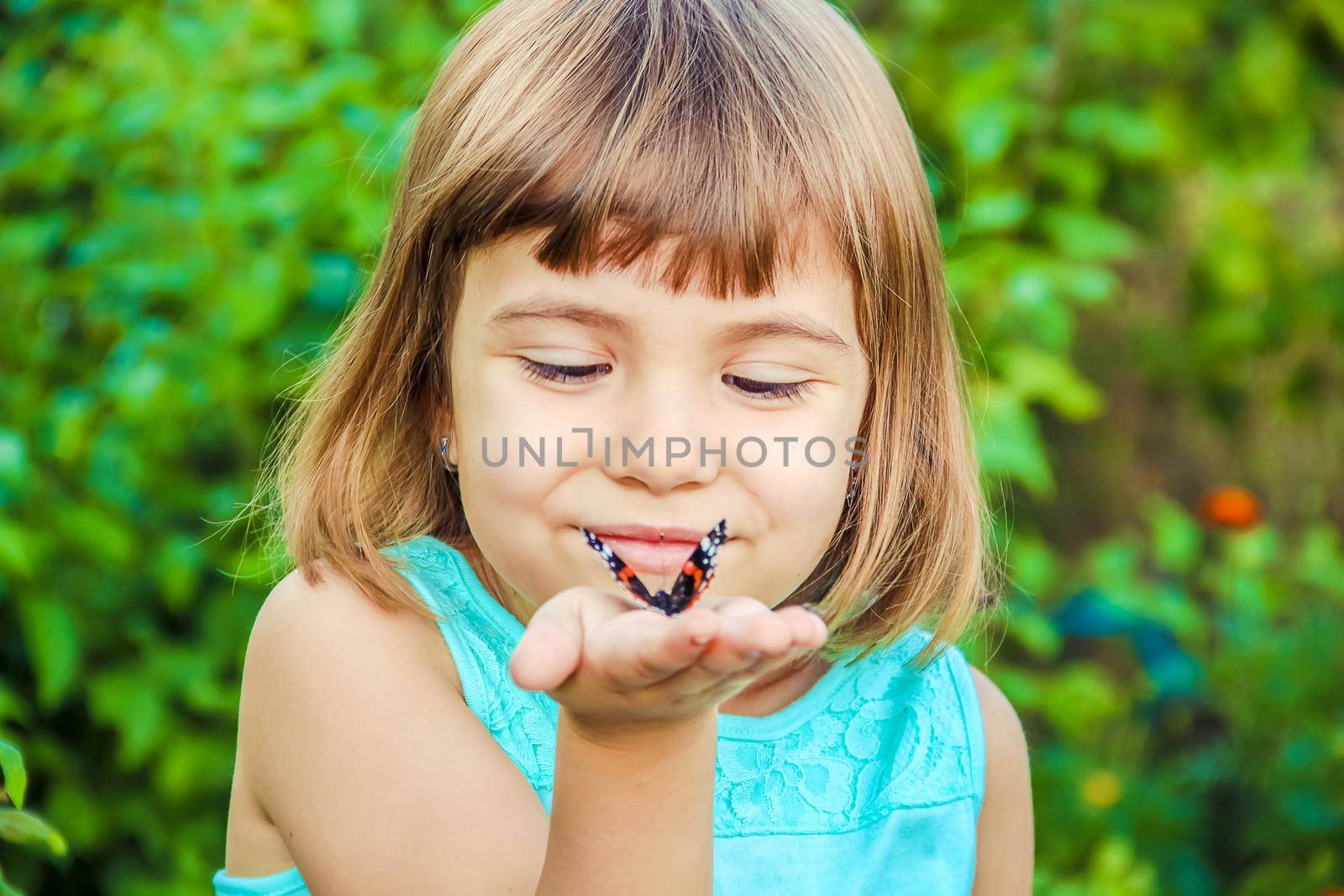 Child with a butterfly. Selective focus. nature and child.