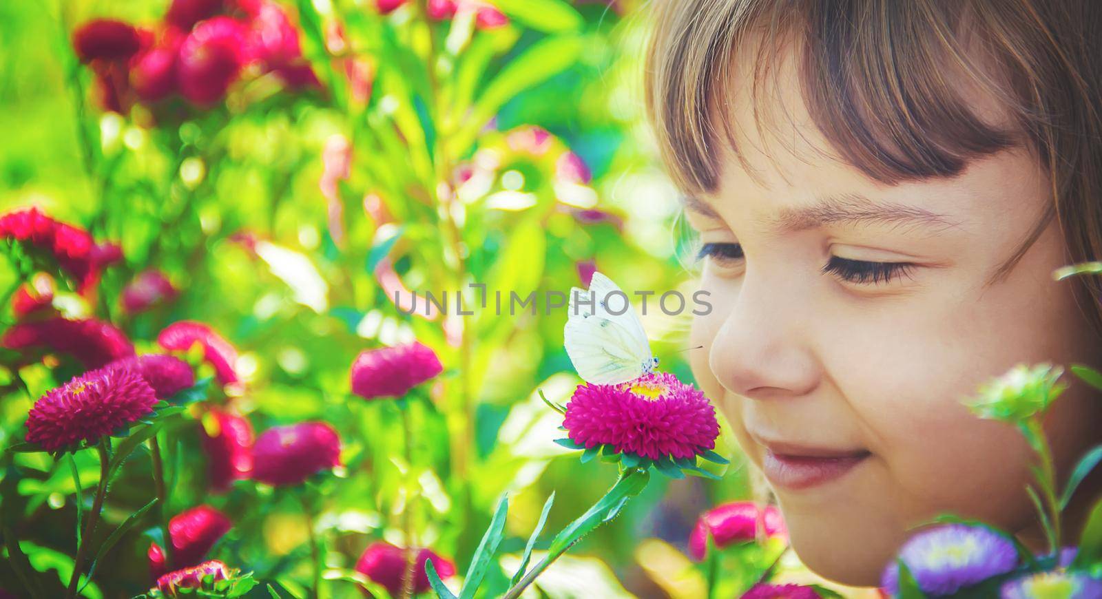 Child with a butterfly. Selective focus. nature and child.