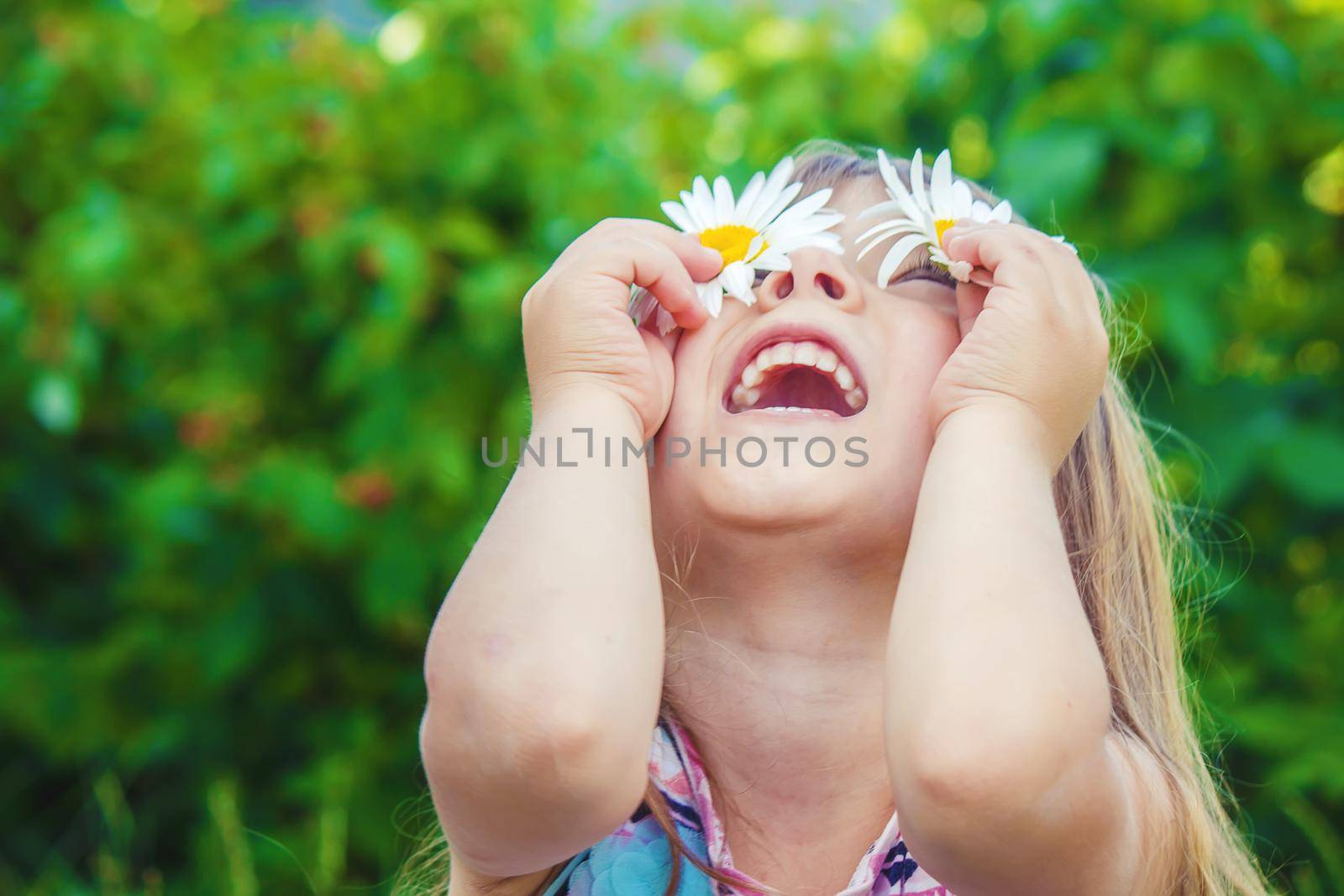 Girl with chamomile. Selective focus. nature flowers. by yanadjana