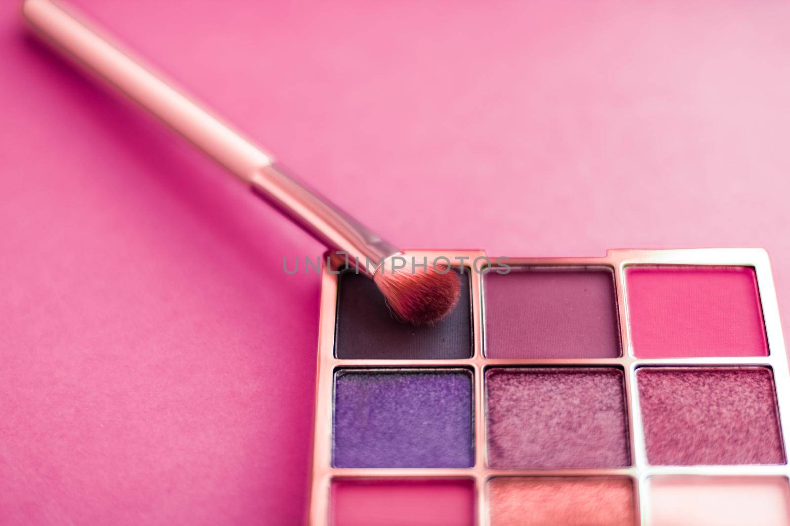 Cosmetic branding, mua and girly concept - Eyeshadow palette and make-up brush on pink background, eye shadows cosmetics product as luxury beauty brand promotion and holiday fashion blog design