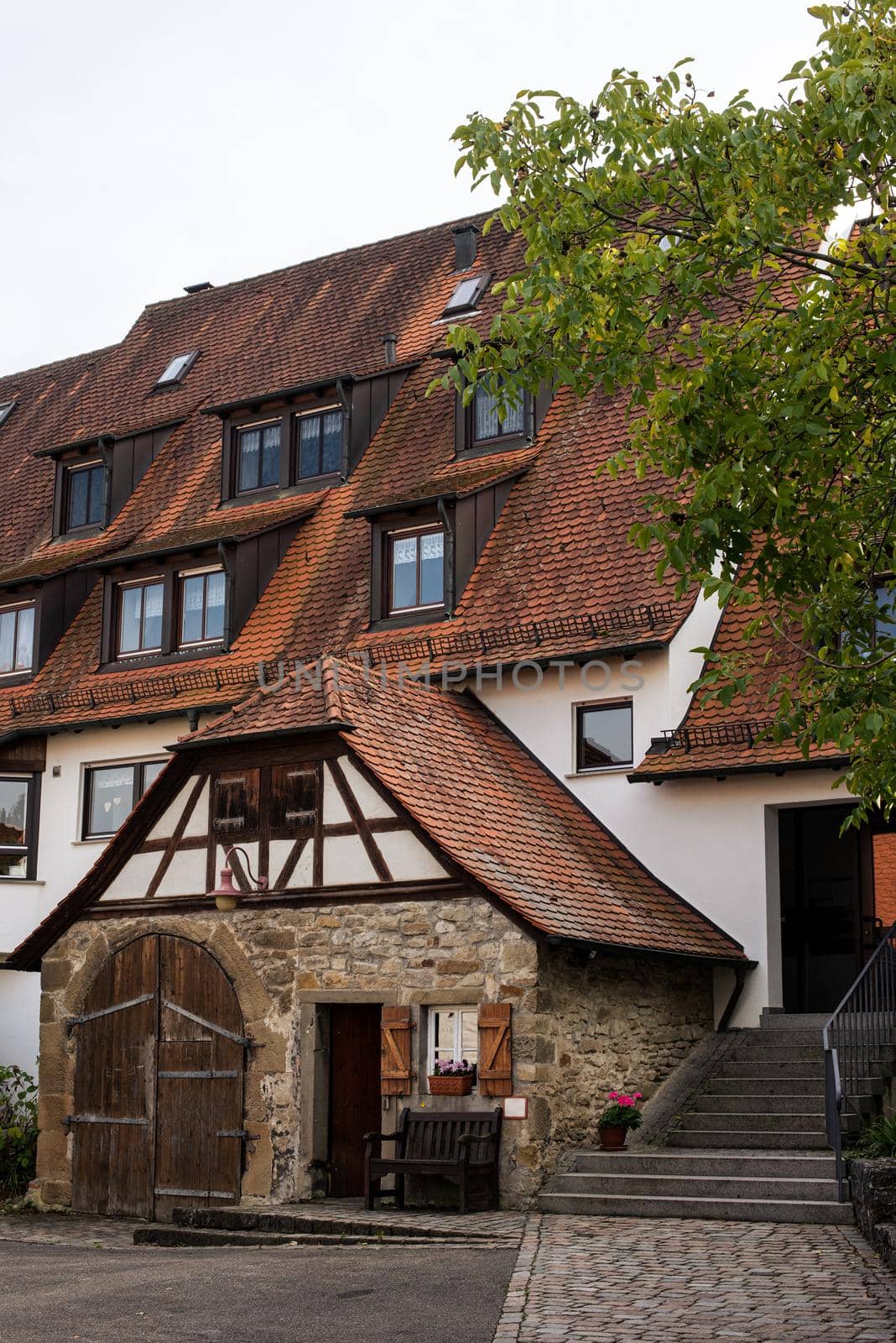 Traditional small house with beautiful outdoor decor facade in Germany. German old brick building house ancient European city German architect by Andrii_Ko