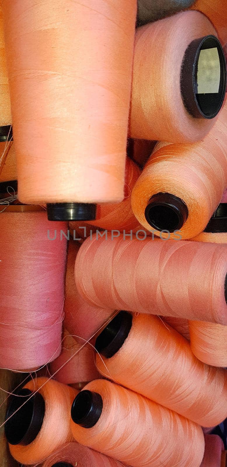 Colorful yarn on spool, yarn on tube, cotton, wool, linen thread orange by antoksena