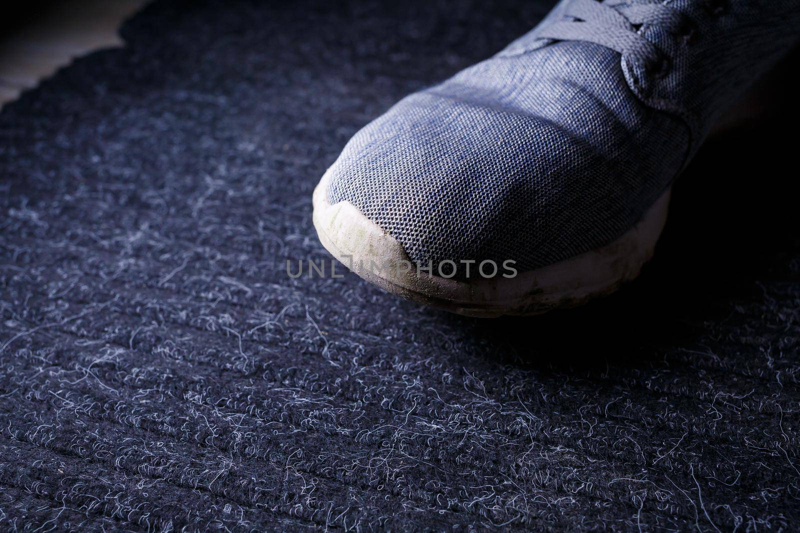 Gray men's sneakers with a dirty sole from the earth and grass, shoes for jogging and sports