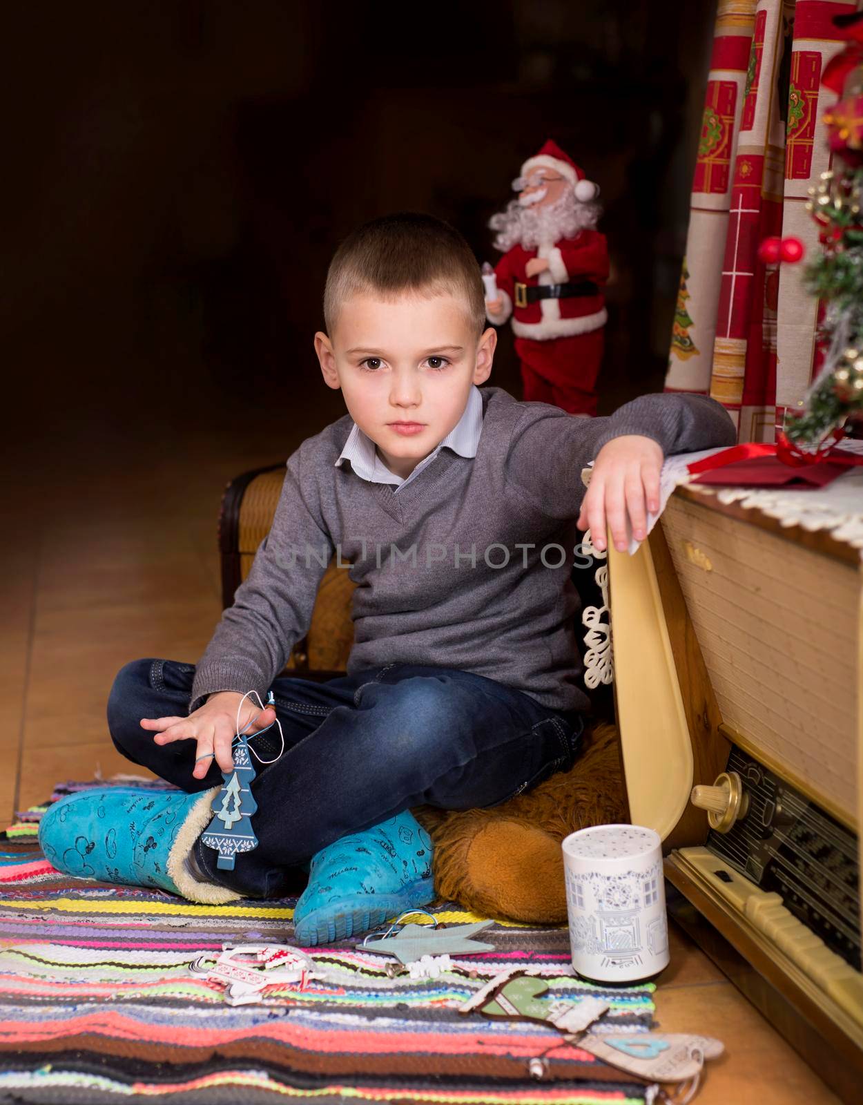 boy in the interior of the house decorated for the new year and christmas