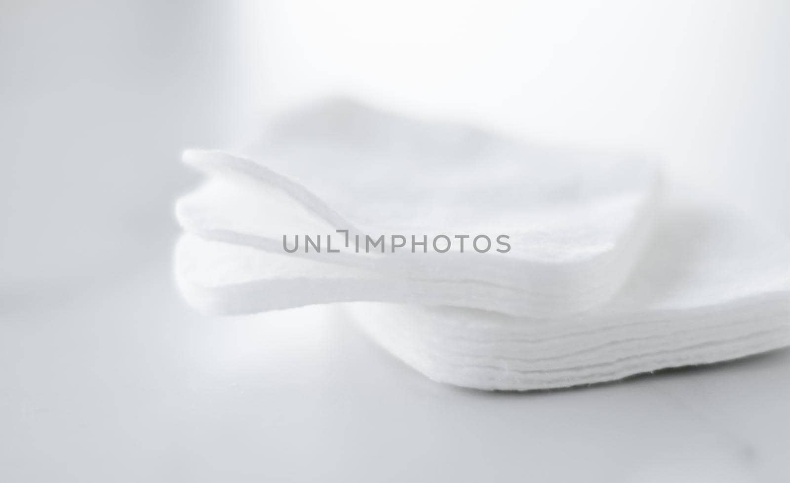 Cosmetology, cleanliness and branding concept - Organic cotton pads on marble background, cosmetics and make-up remover, hygiene and skincare beauty brand product for healthcare and medical design