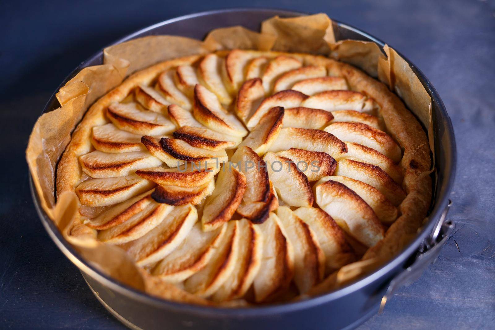 Homemade cinnamon pastry, sweet freshly baked apple tart, traditional French apple pie from the oven, baking dish