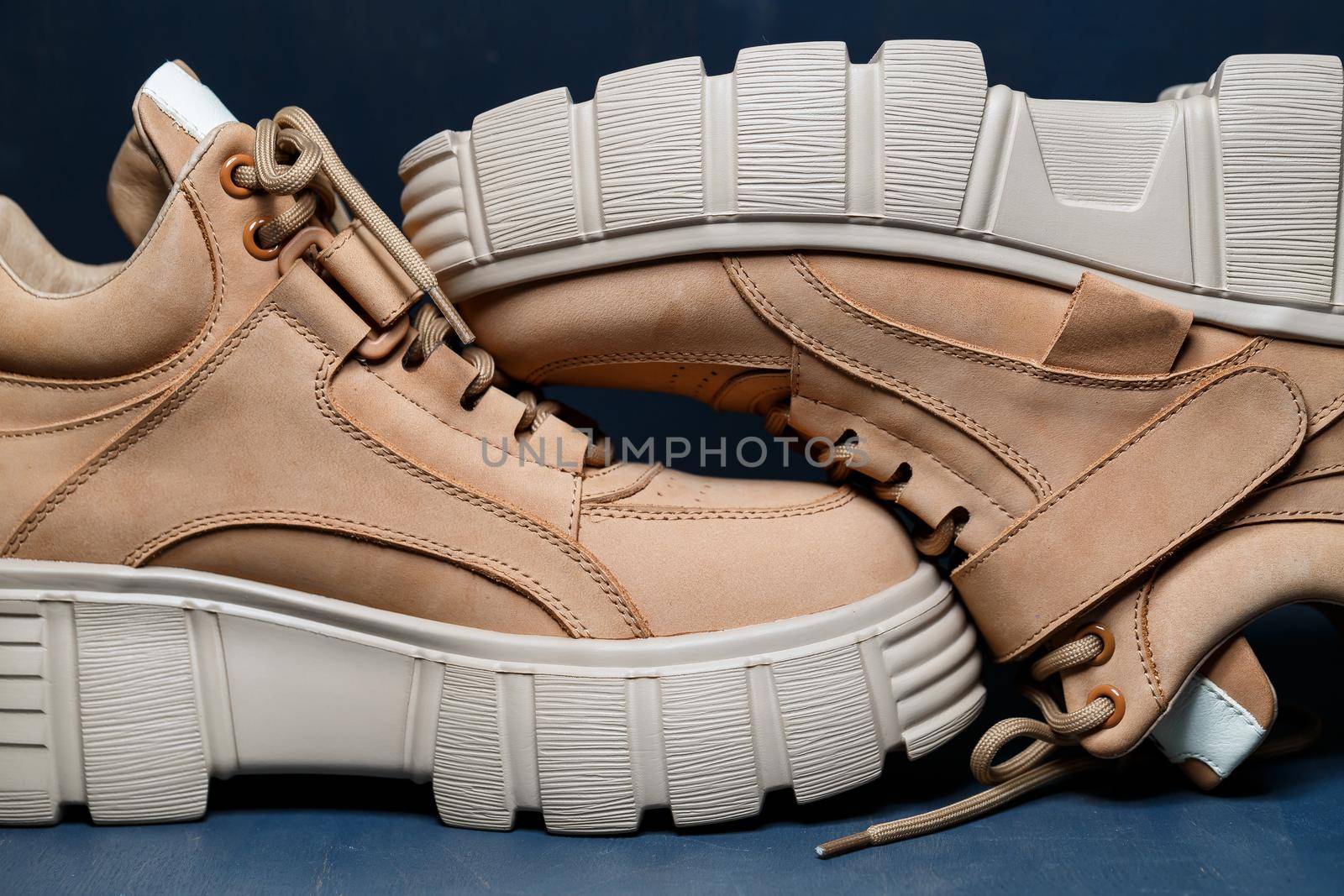 Brown women's leather shoes on a gray background. Fashion trend