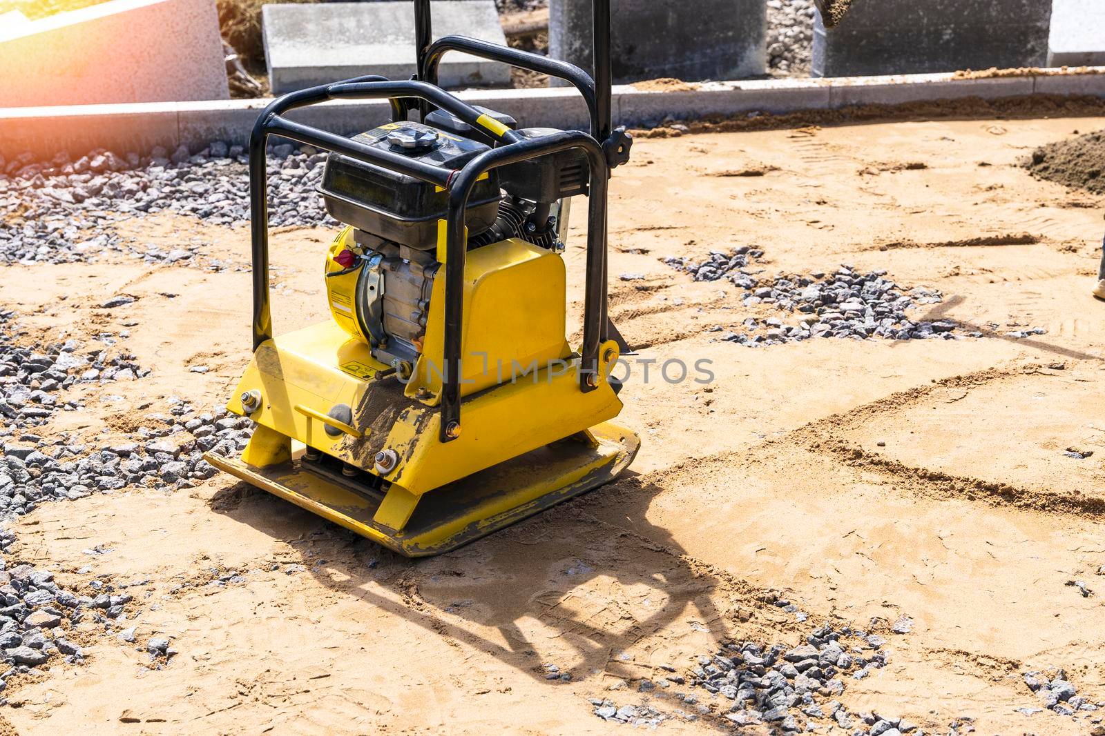 construction gasoline vibration rammer. Ramming construction equipment for leveling roads. soil compaction on the construction site, sand compaction. Gasoline manual vibration compactor for road works. High quality photo