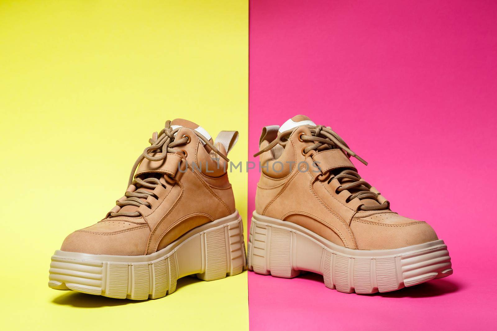 Brown women's leather shoes on a colored background. Fashion trend
