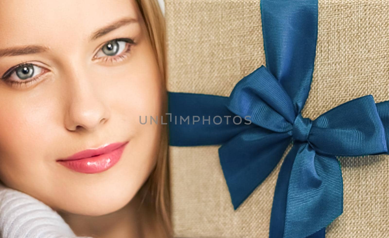 Winter holidays, present and Merry Christmas concept, happy woman smiling and holding wrapped gift box, close-up portrait