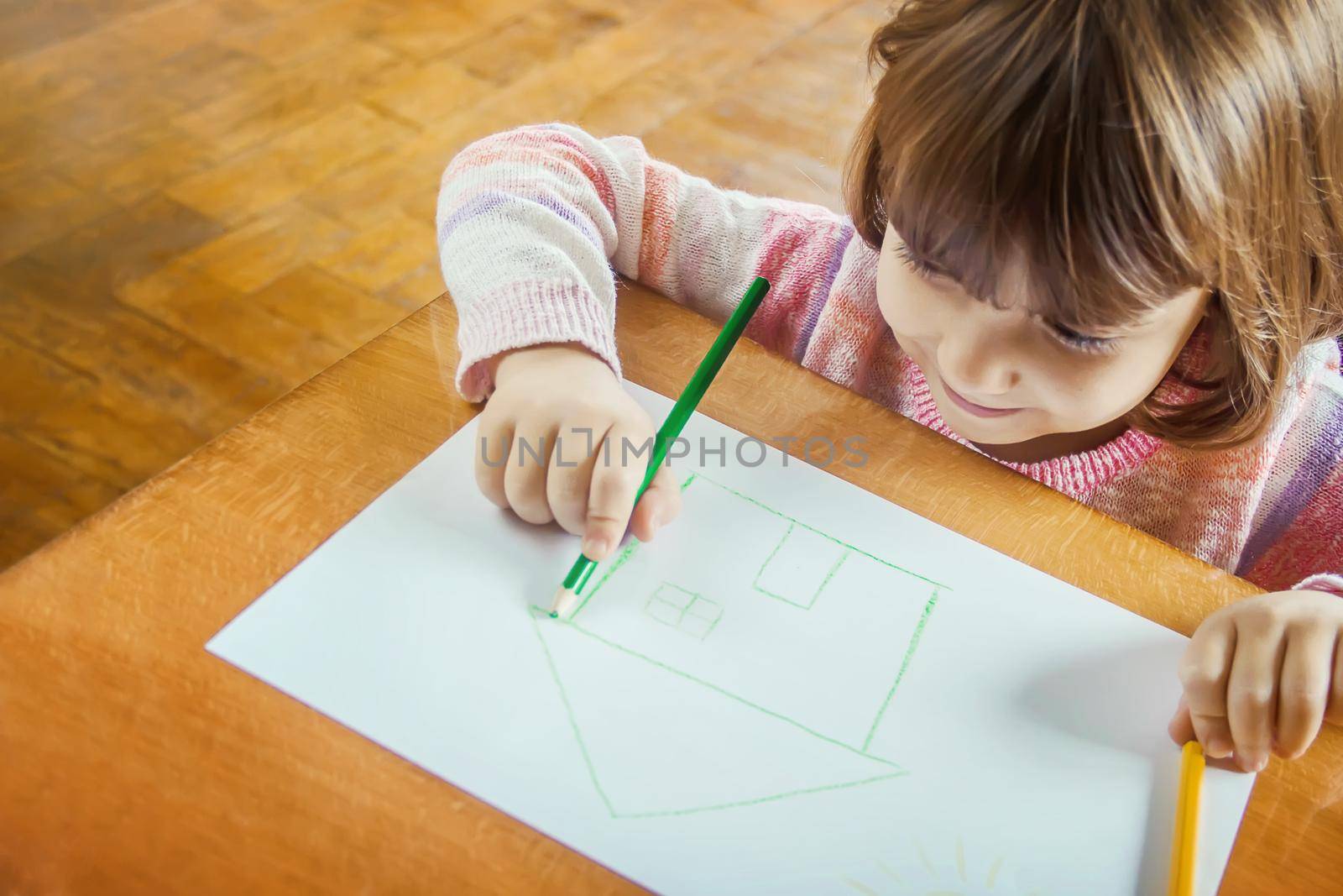 draw child house family. Selective focus. Kids draw.