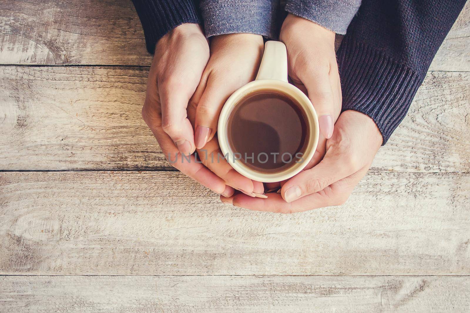 Tea in hand. The lovers are together. Selective focus. Drink.