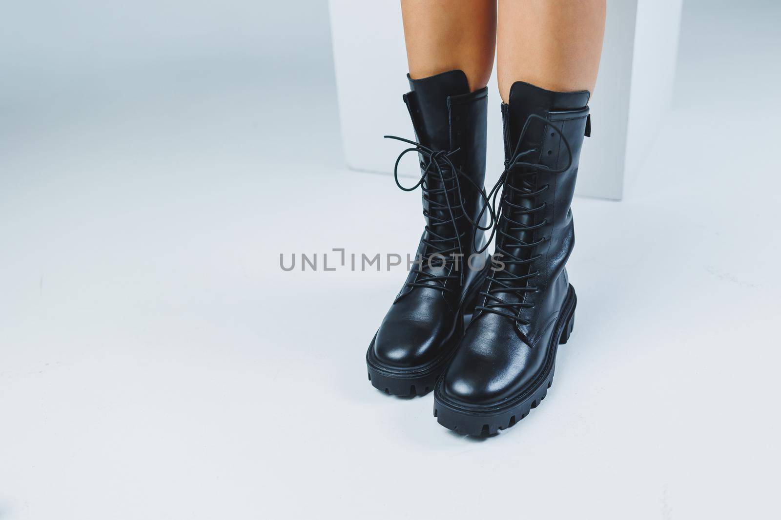 Close-up of female legs in black leather lace-up shoes. New autumn collection of women's leather shoes 2022