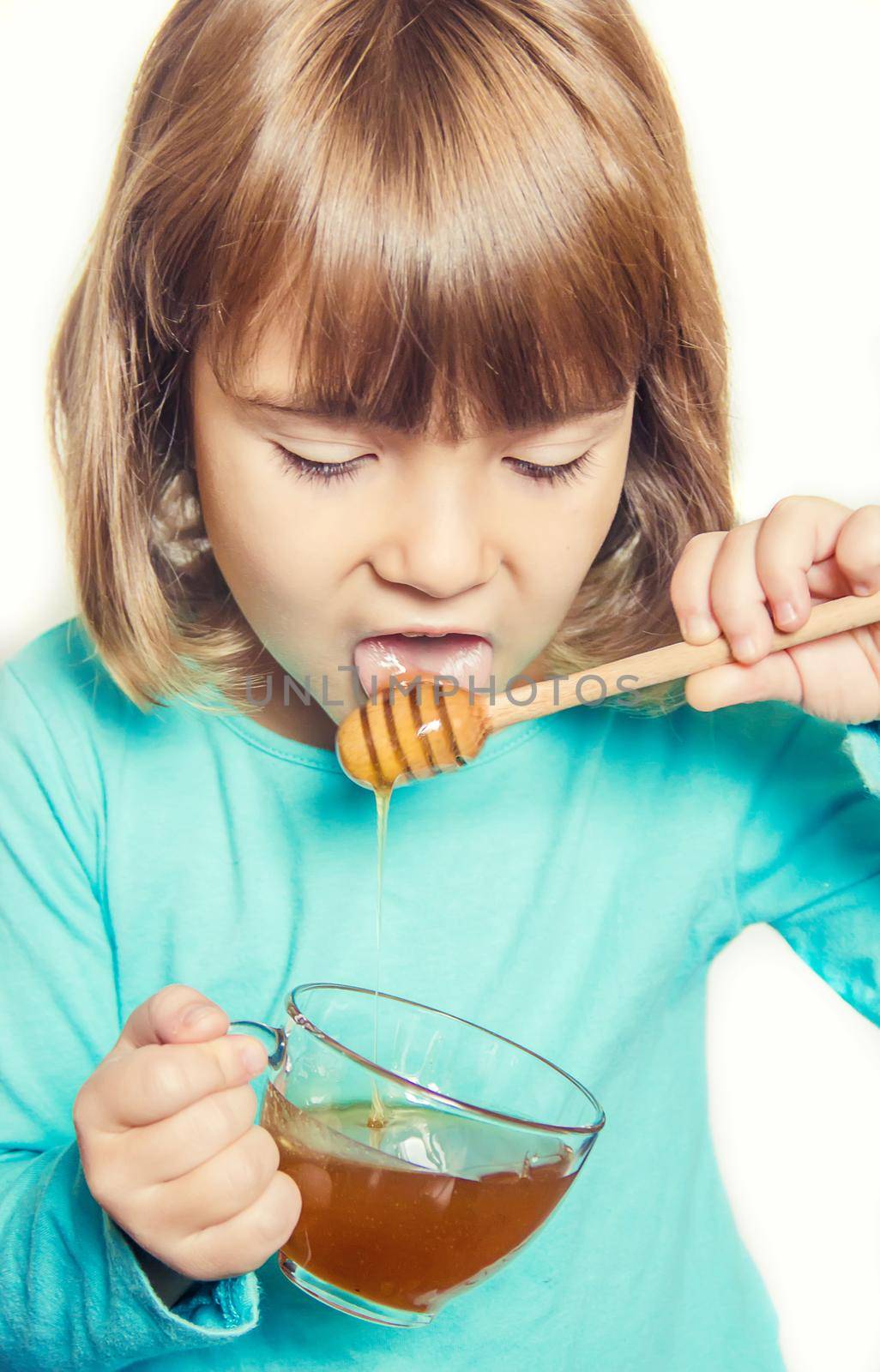 The child eats honey. Selective focus. nature food