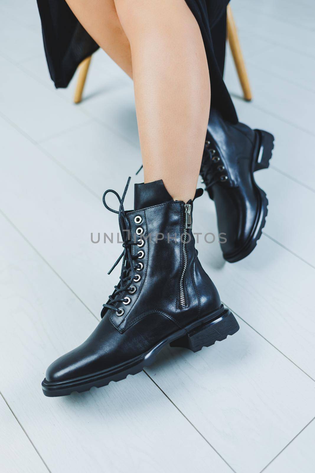 Fashionable leather boots with laces on a woman's leg, close-up, fashionable. New collection of leather autumn women's shoes
